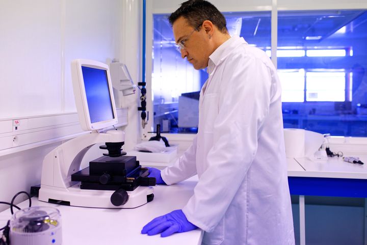 Technician using a microscope